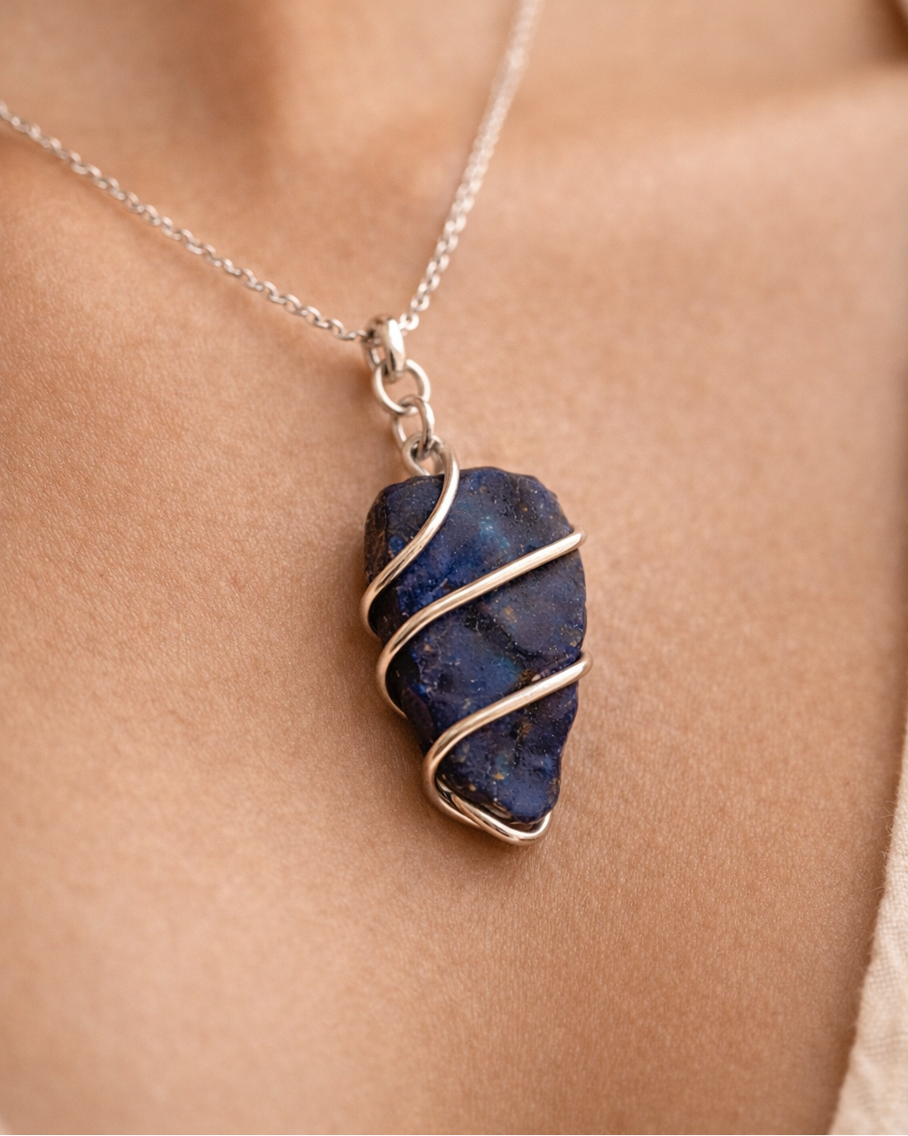 Necklace with a blue stone pendant on a person's neck