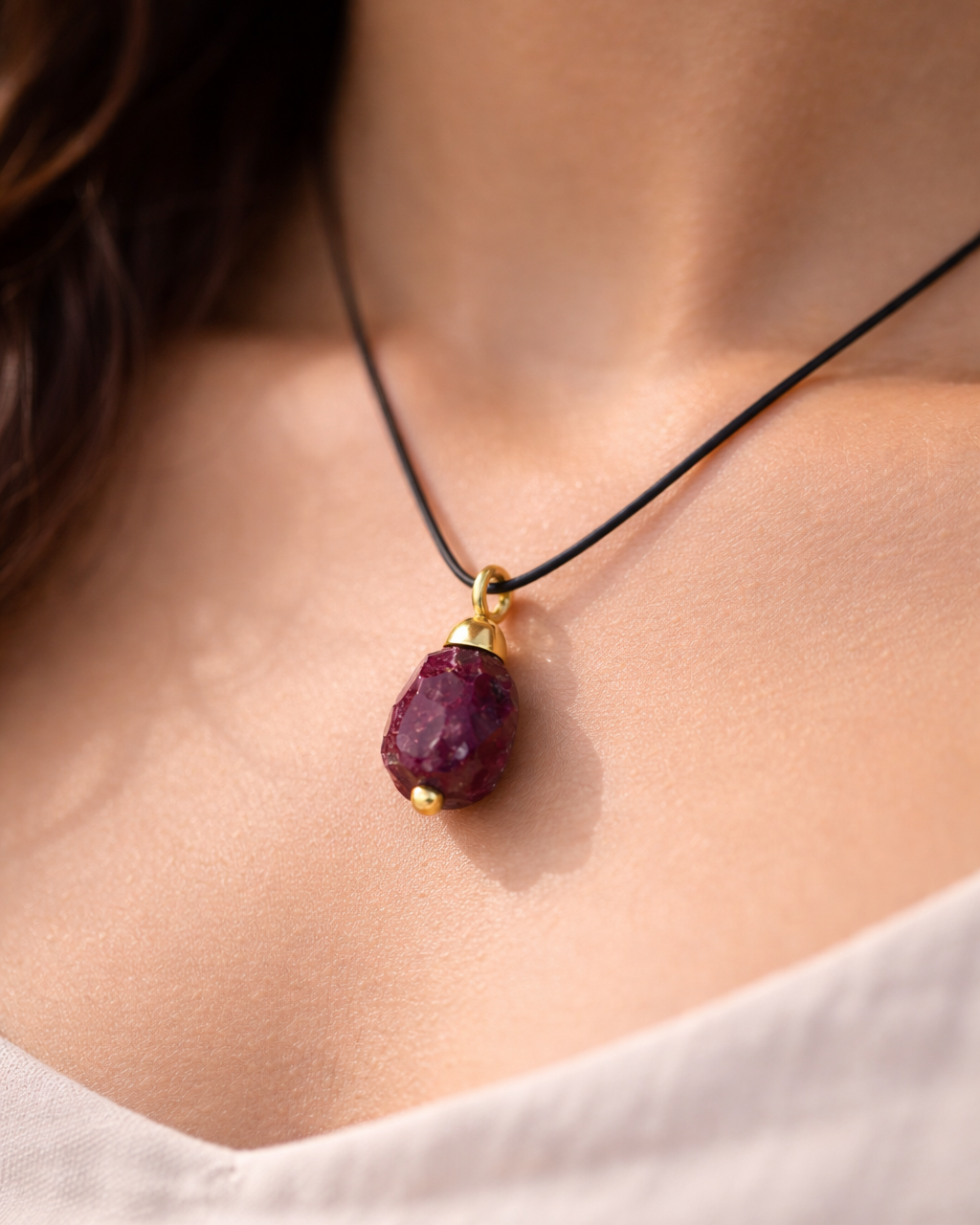Elegant garnet necklace on Indian skin tone model black cord