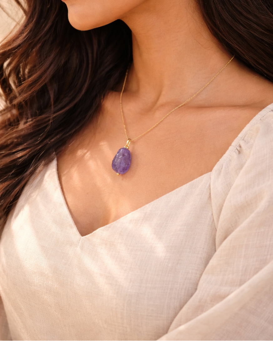Elegant amethyst pendant on Indian skin tone model gold chain