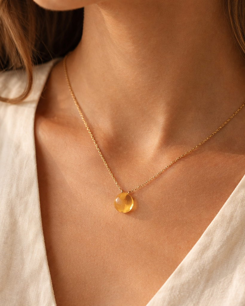 woman wearing citrine heart shaped drop pendant necklace minimal elegant jewelry