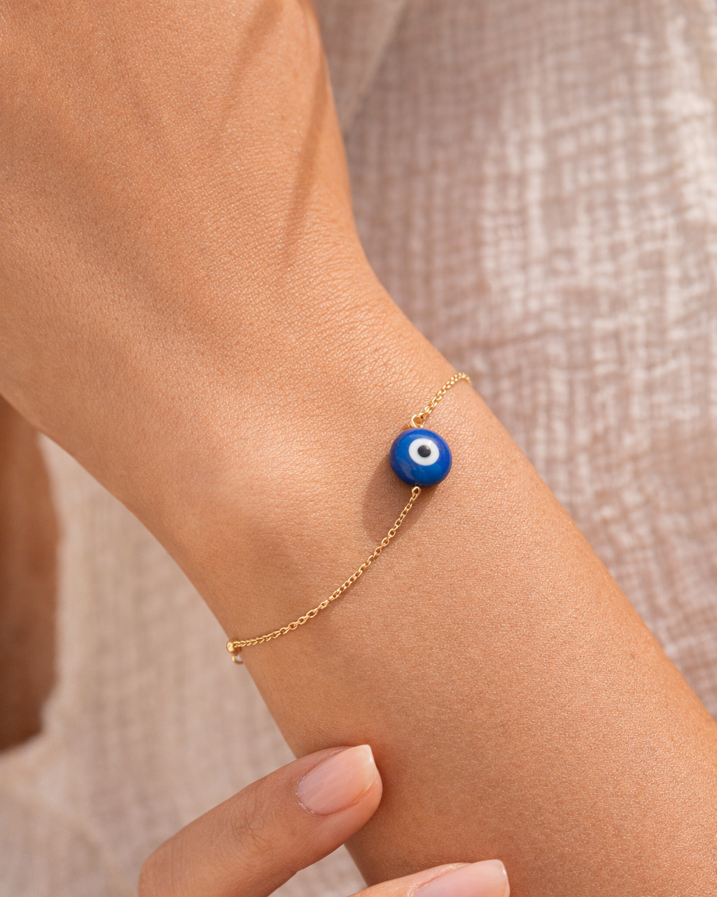 woman wearing lapis lazuli evil eye bracelet minimal jewelry