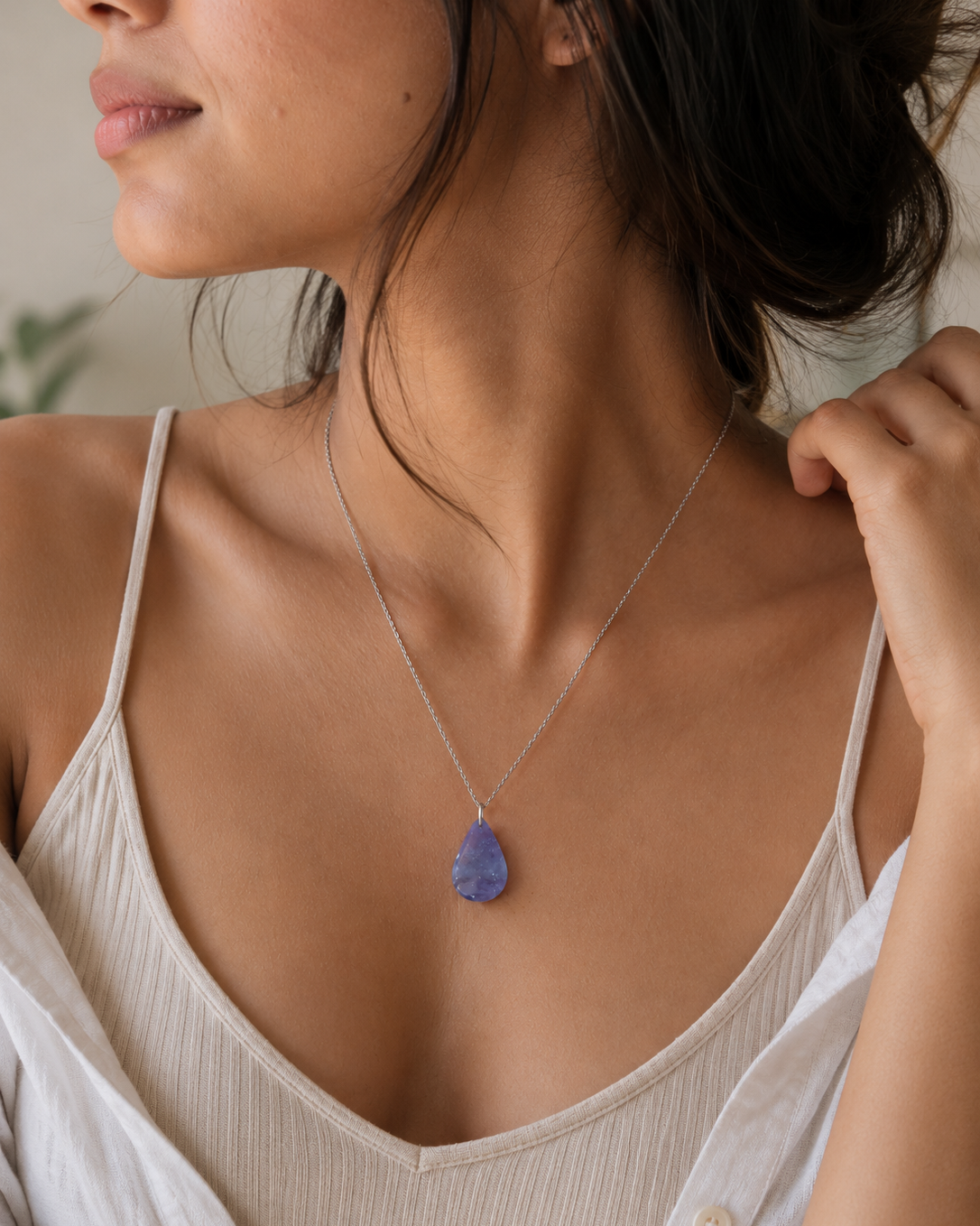 Close-up of natural Amethyst teardrop pendant necklace on silver chain
