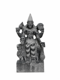 A dark gray stone statue of a multi-armed Hindu deity, likely Lord Hanuman, standing on a rectangular base against a plain white background.