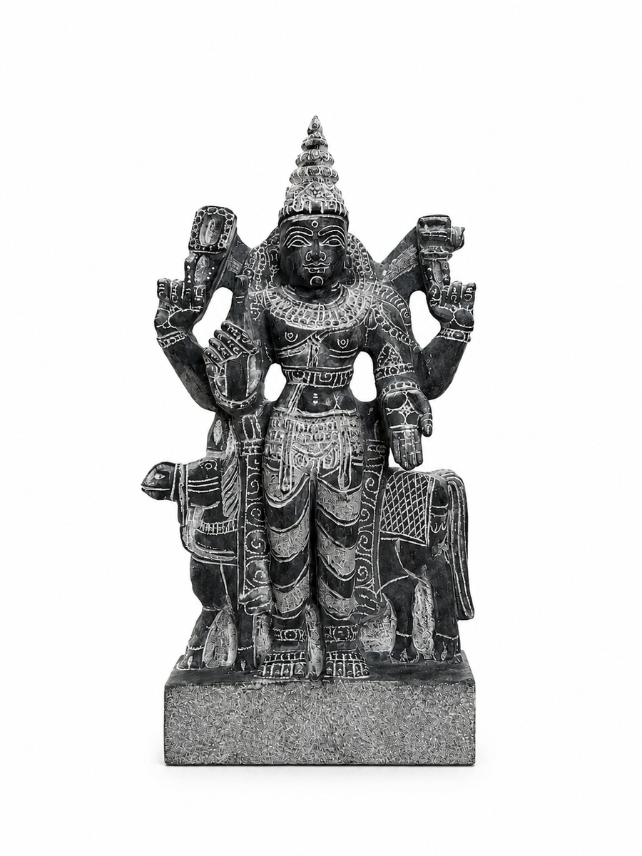 A dark gray stone statue of a multi-armed Hindu deity, likely Shiva, standing on a rectangular base against a plain white background.