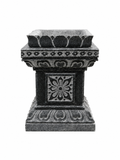 A dark gray stone planter pedestal with ornate carved floral and geometric patterns, isolated on a white background.