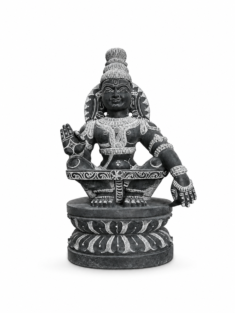 A dark gray stone statue of a Hindu deity seated on a lotus pedestal, featuring detailed light-colored carvings and a serene expression, isolated on a white background.