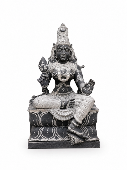 A dark gray and silver stone statue of a seated Hindu deity with ornate carvings, shown against a plain white background.