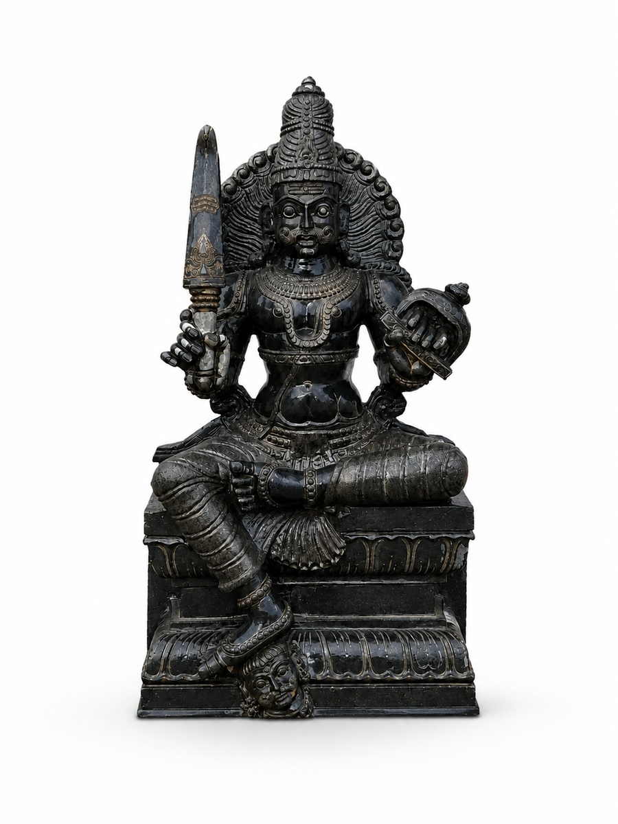 A dark metallic Hindu deity statue seated on a pedestal, holding a sword and an axe, photographed against a plain white background.