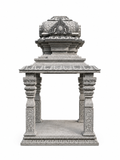 A gray stone replica of a traditional Indian temple shikhara, featuring intricate carvings and a tiered structure, isolated on a white background.