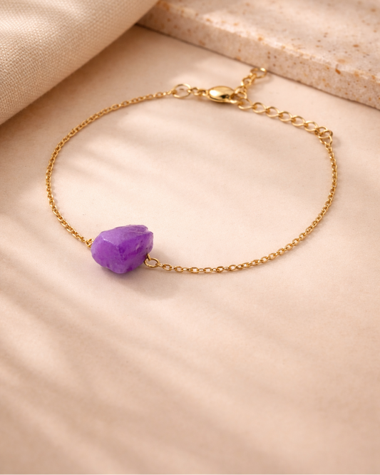 Amethyst stone gold plated bracelet on beige aesthetic background