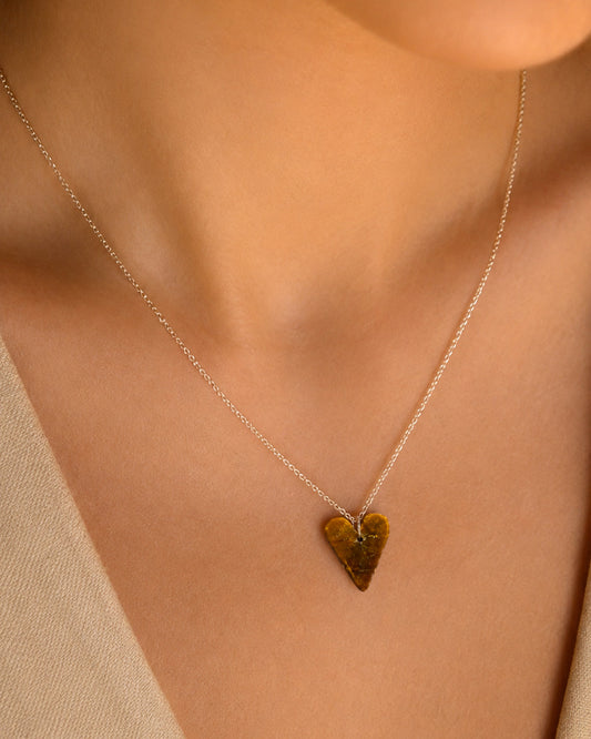 Tiger Eye Heart-shaped pendant necklace on a person with a neutral background