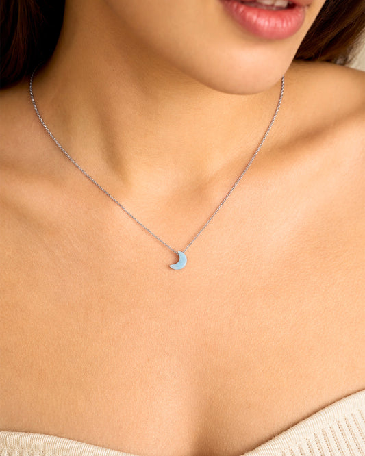person wearing natural aquamarine crescent moon pendant rex stones