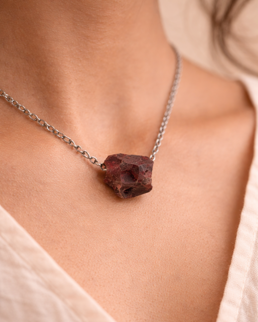 Close-up of raw garnet gemstone pendant minimal style