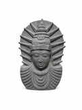 A gray stone sculpture of a stylized face with a crown and radiating halo-like rays, centered on a plain white background.