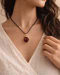 Handcrafted raw garnet pendant black cord necklace lifestyle shot