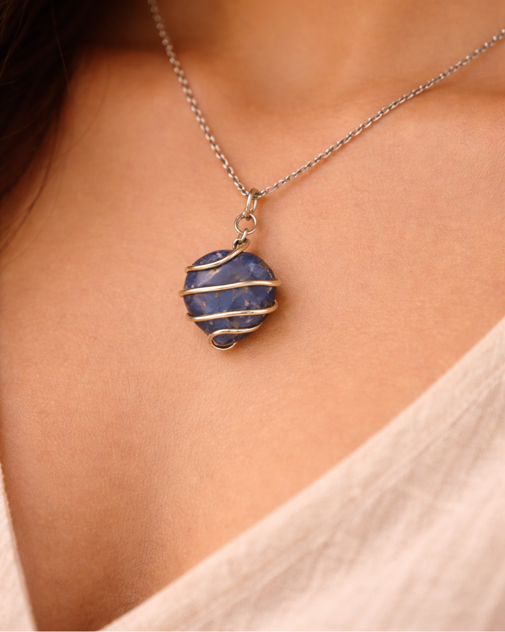 Necklace with a blue pendant worn by a person
