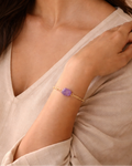 Close-up of purple amethyst gemstone gold bracelet