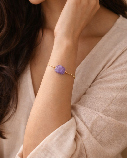 Woman wearing amethyst gold chain bracelet minimal style