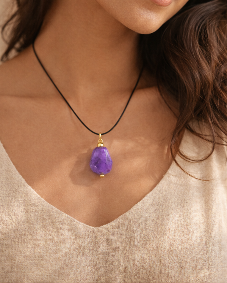 Woman wearing amethyst stone wire pendant black cord necklace