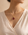 Woman wearing natural garnet pendant with gold plated chain