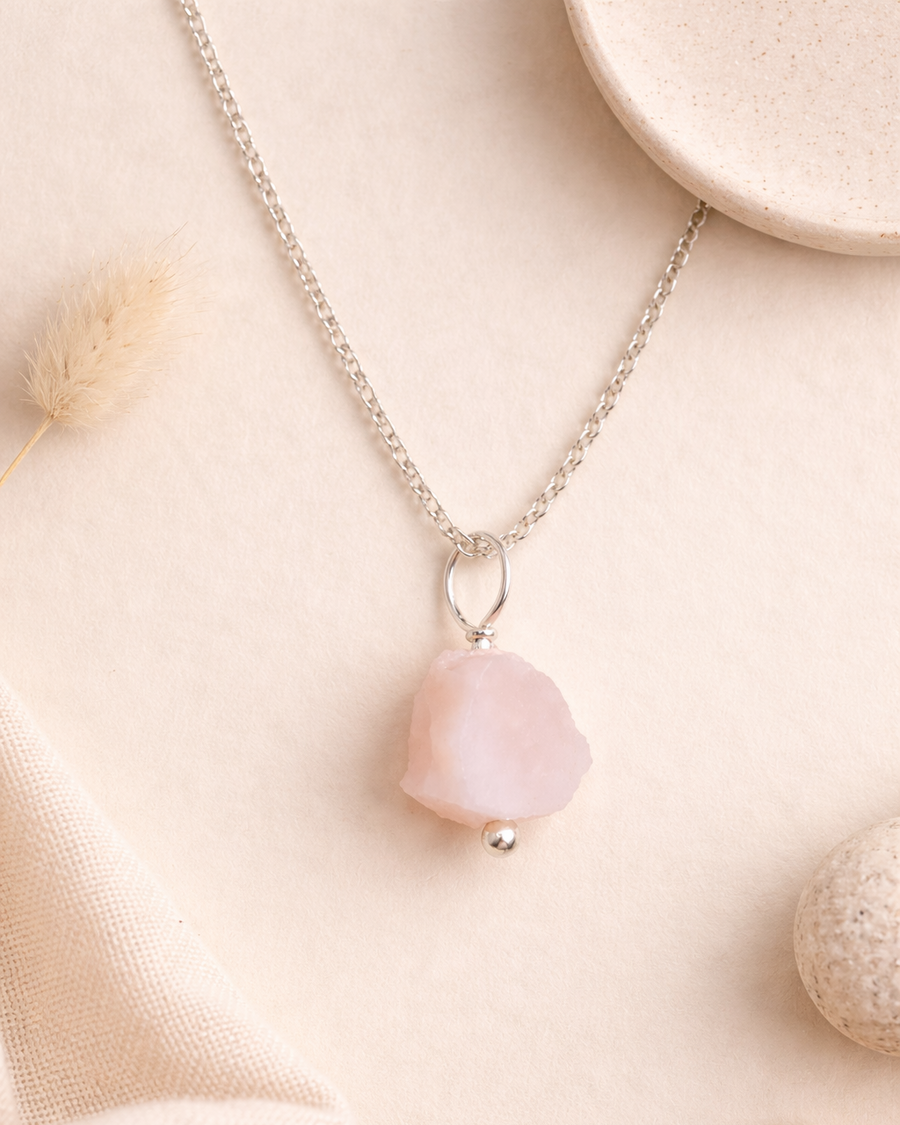 Necklace with a pink pendant on a soft beige background