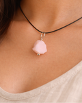 Necklace with a pink pendant worn by a person
