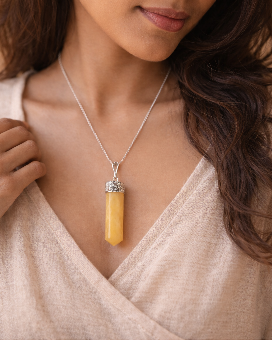 Woman wearing a necklace with a yellow pendant