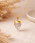 Necklace with a gold pendant on a neutral background
