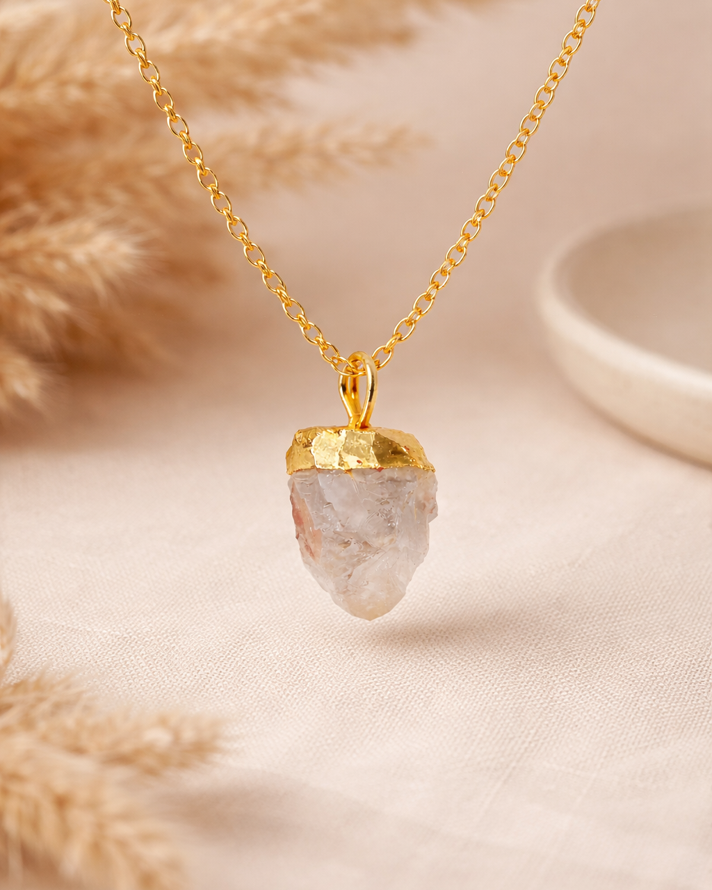 Necklace with a gold pendant on a neutral background