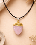 Necklace with a pink pendant and gold accent on a beige background