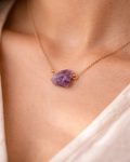 Close-up of purple amethyst stone necklace elegant style