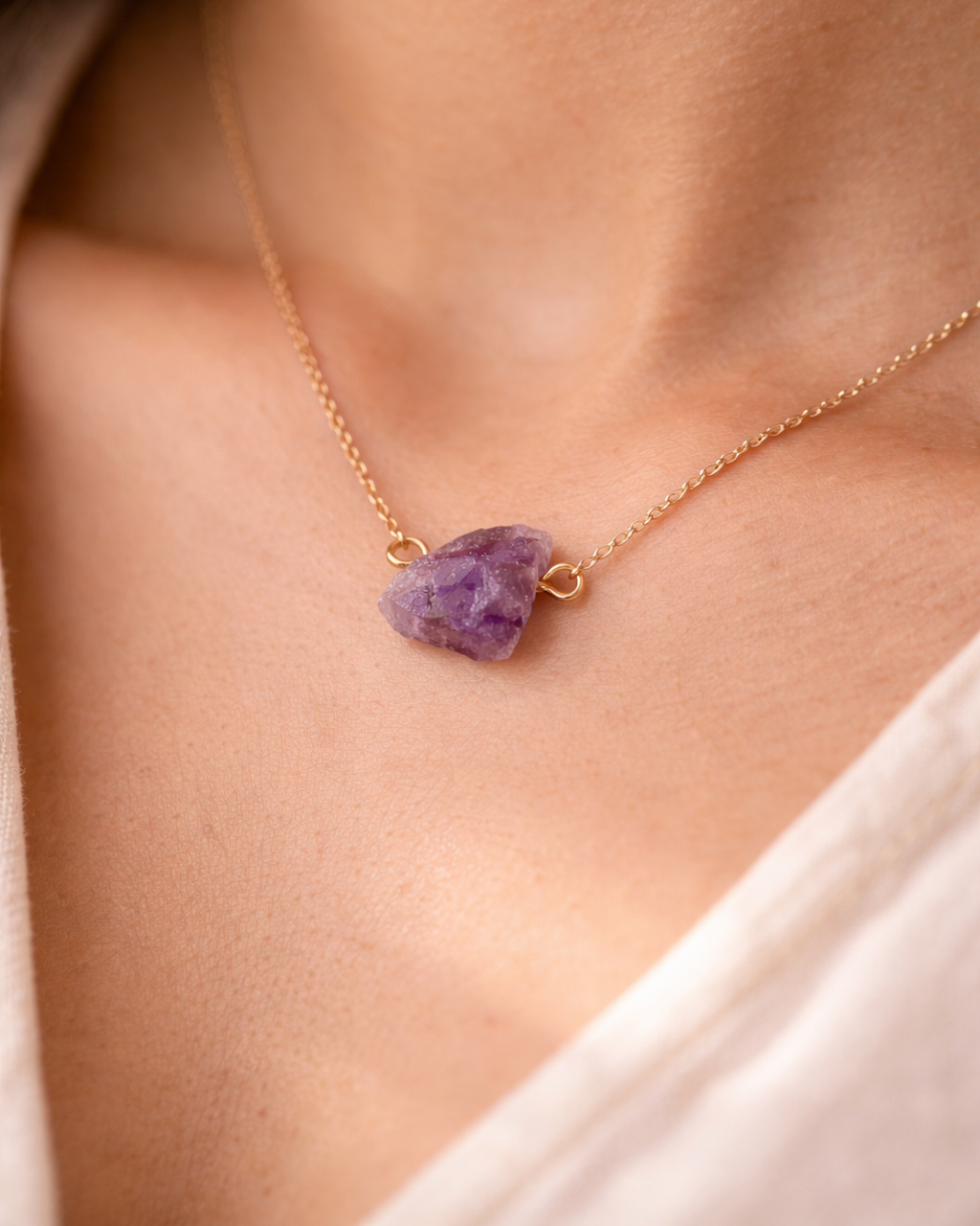 Close-up of purple amethyst stone necklace elegant style