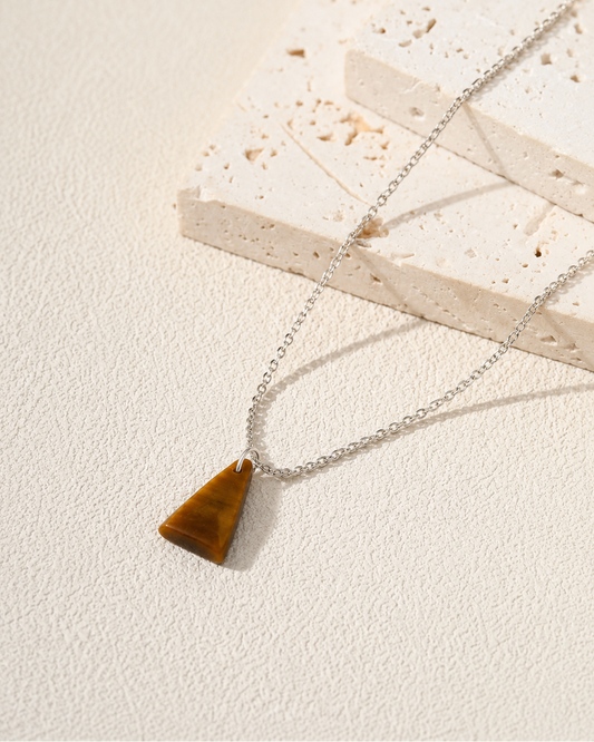 Necklace with a Tiger Eye triangular pendant on a light background