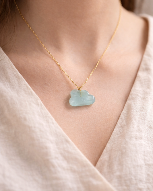 Delicate gold necklace with aquamarine cloud pendant worn on neck, elegant everyday jewelry style
