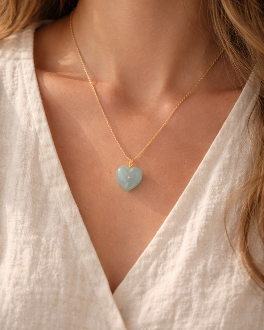 woman wearing aquamarine heart pendant necklace minimal elegant jewelry