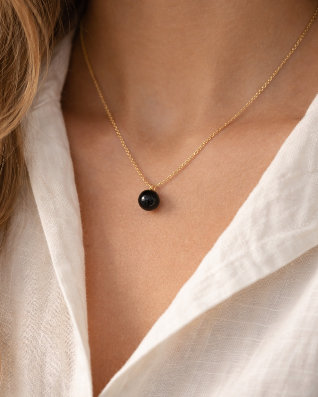 woman wearing black onyx heart drop pendant necklace minimal elegant jewelry