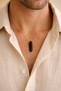 man wearing black onyx bullet pendant minimal jewelry