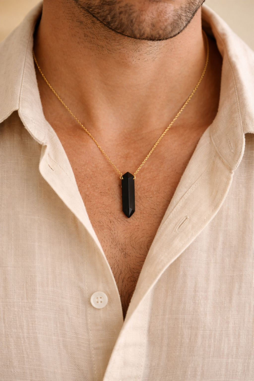 man wearing black onyx bullet pendant minimal jewelry