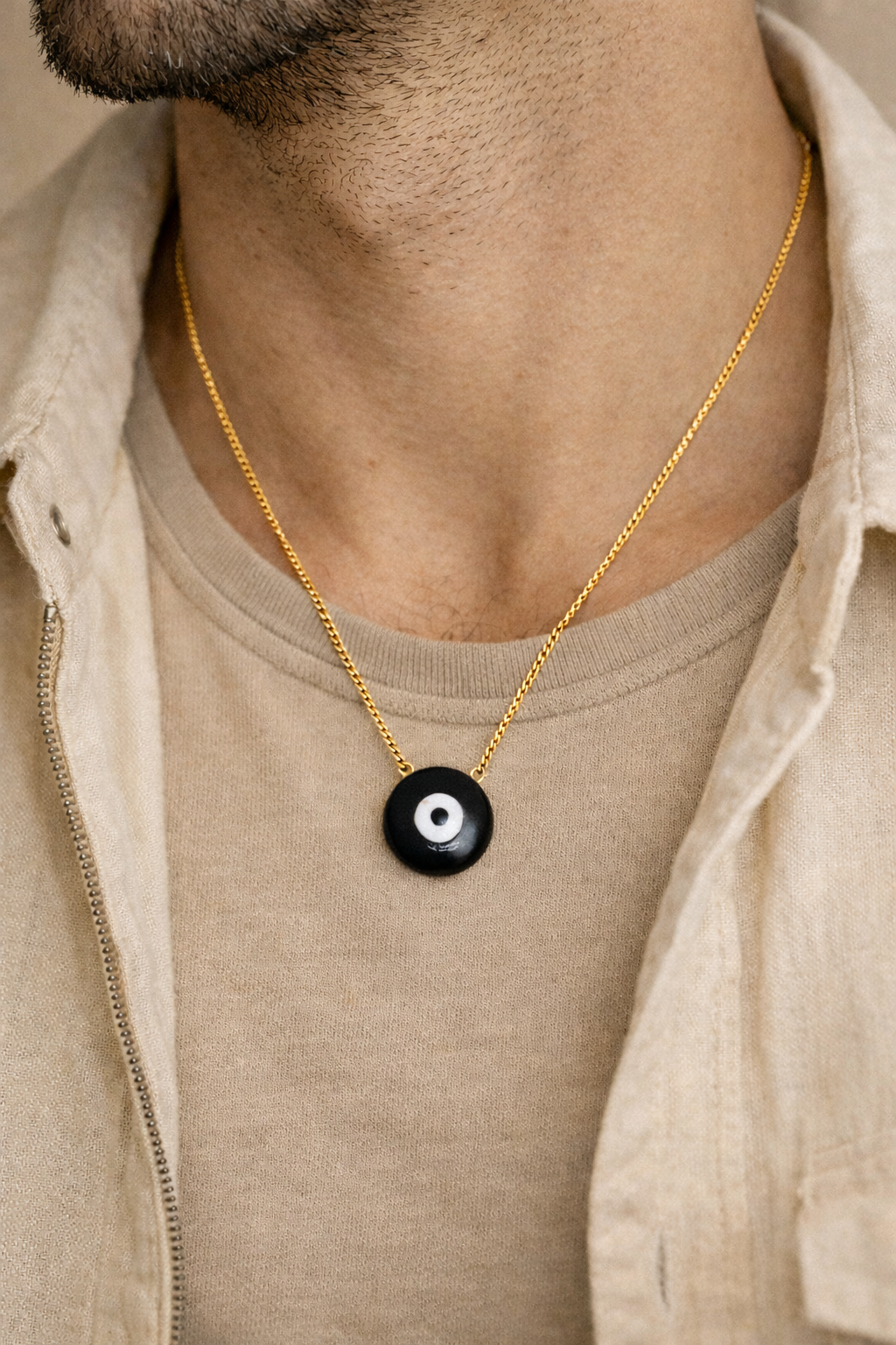 man wearing black onyx evil eye pendant minimal jewelry