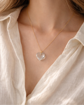 woman wearing clear quartz heart pendant necklace minimal elegant jewelry