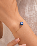 woman wearing lapis lazuli evil eye bracelet minimal jewelry