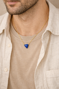 man wearing lapis lazuli tikona pendant minimal masculine jewelry