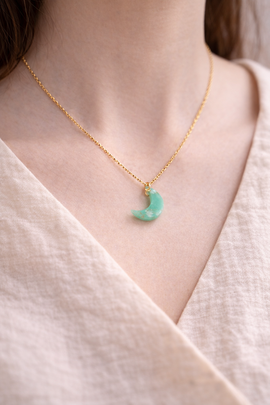 Delicate gold necklace with malachite crescent moon pendant worn on neck, elegant everyday gemstone jewelry