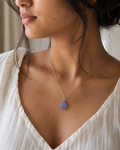 Model wearing natural Amethyst teardrop pendant necklace, white top