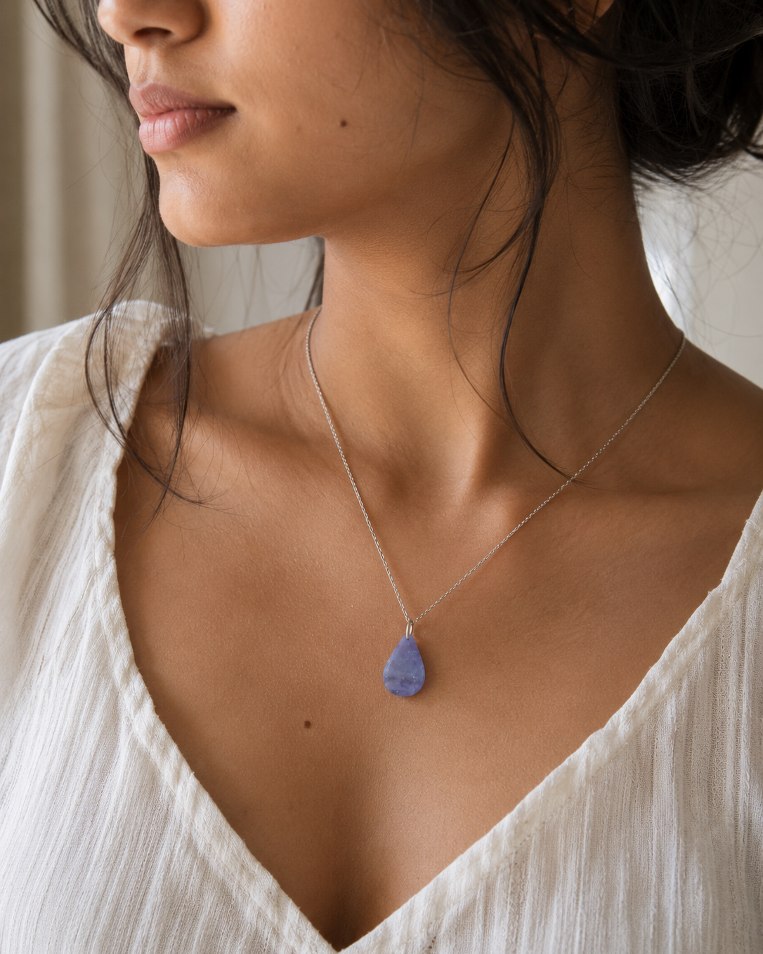Model wearing natural Amethyst teardrop pendant necklace, white top