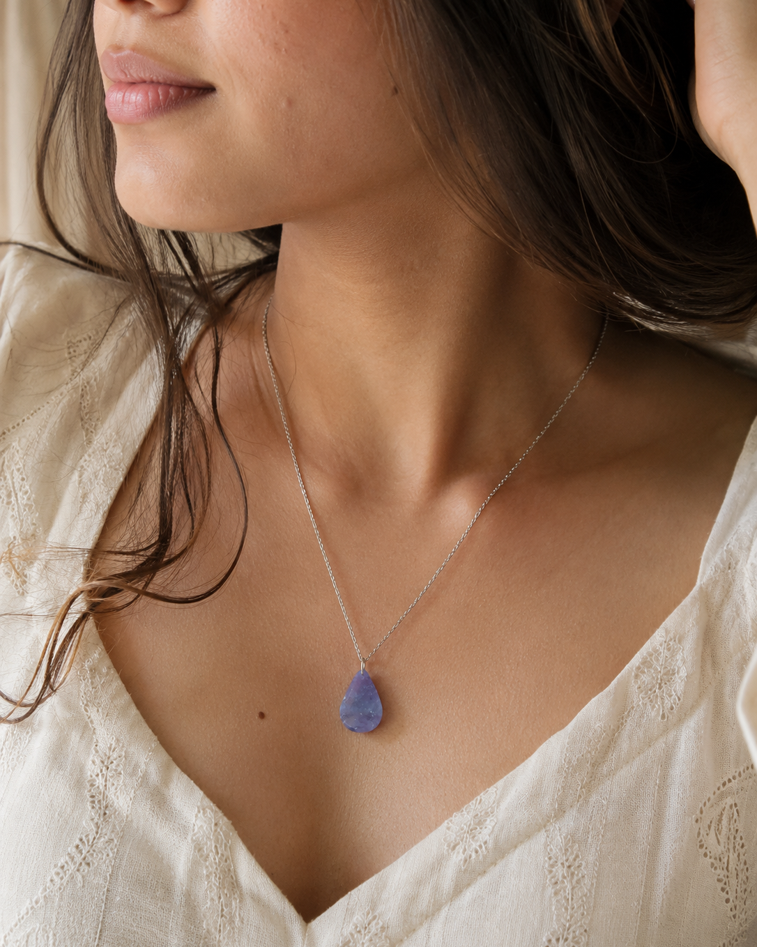 Side view of model wearing natural Amethyst teardrop pendant necklace