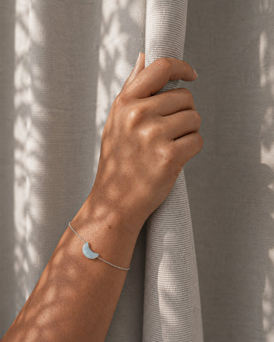 person wearing natural aquamarine crescent moon bracelet rex stones