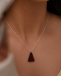 person wearing natural red stone triangle pendant necklace rex stones