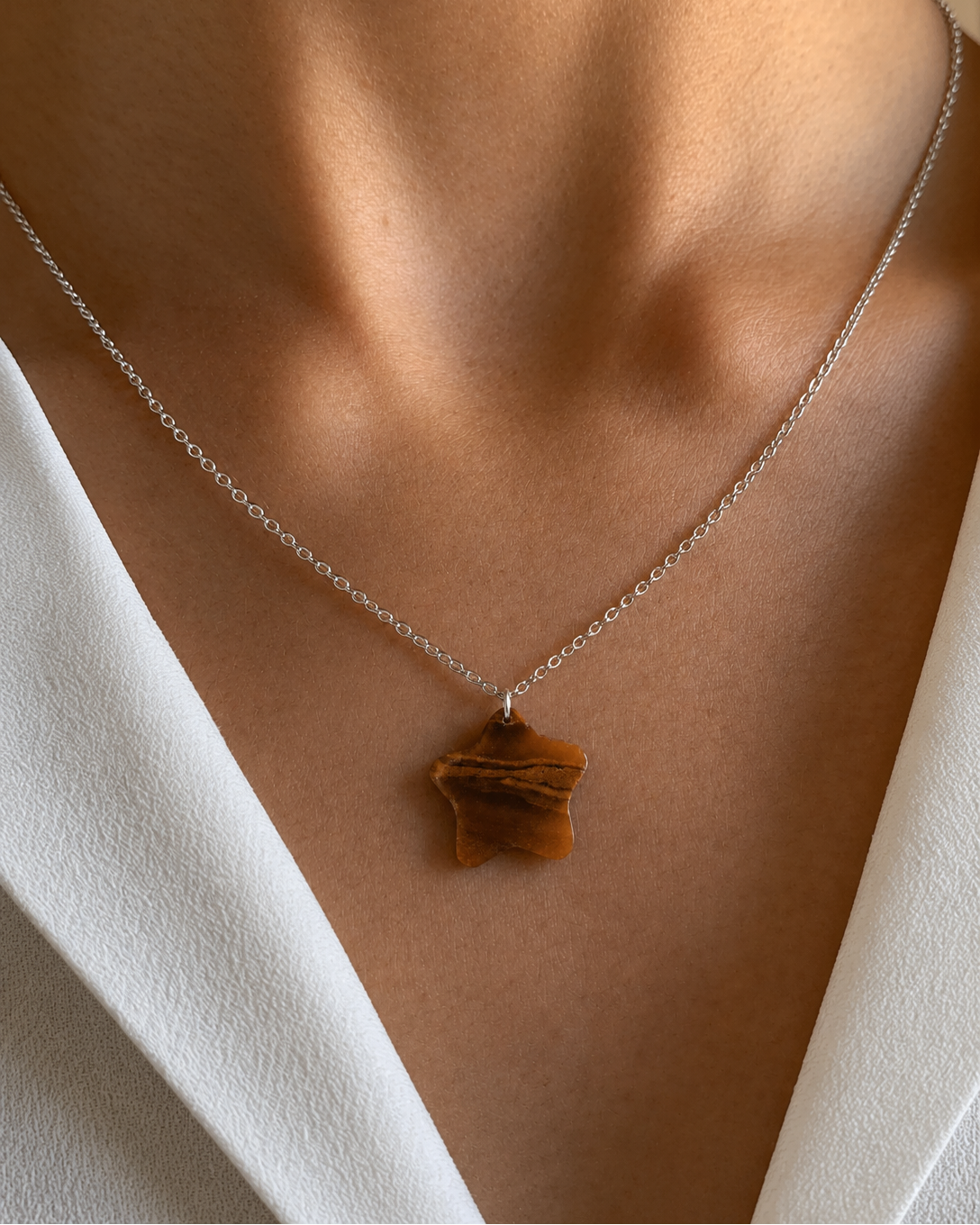 Close-up of natural Tiger Eye star pendant necklace on silver chain
