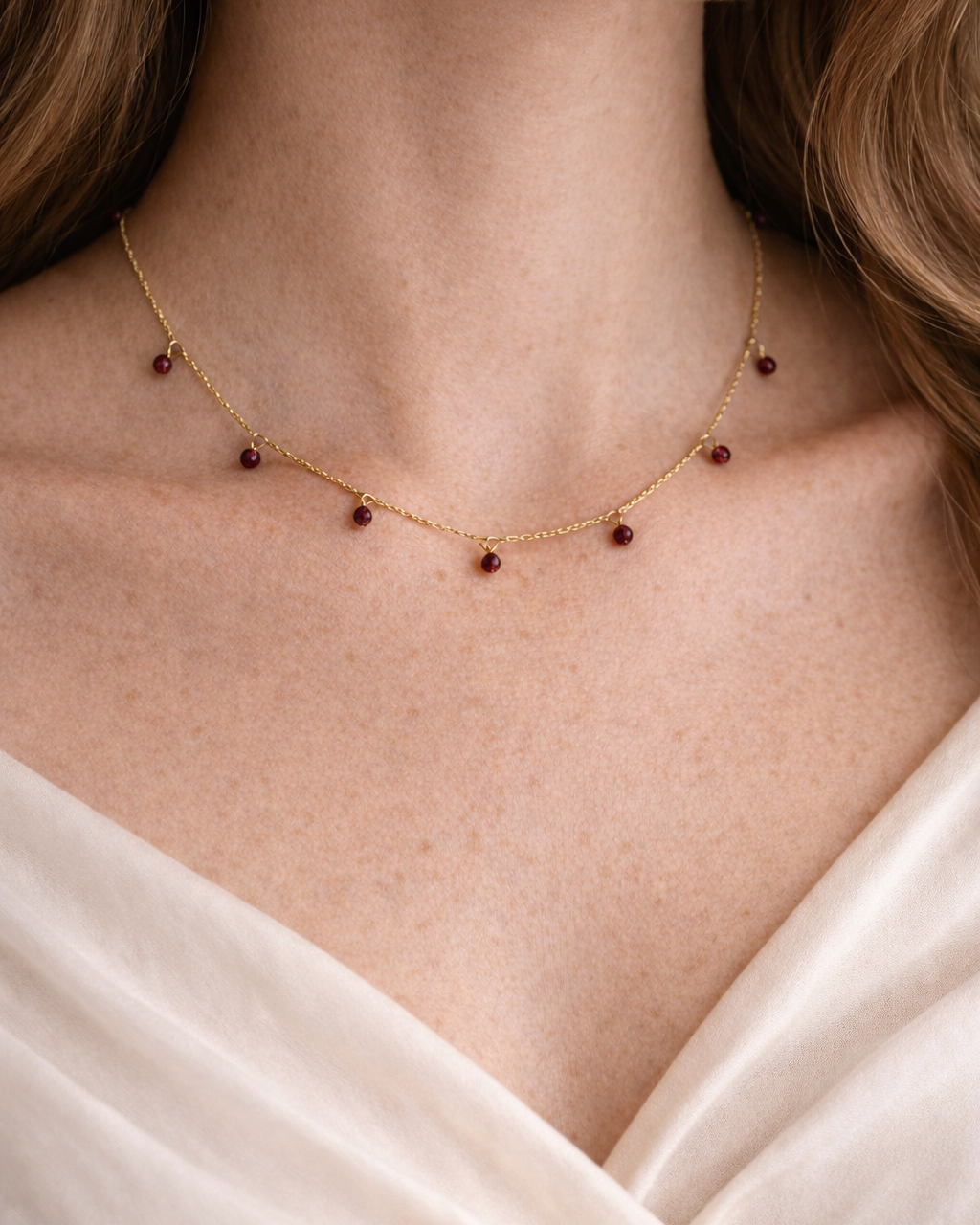 woman wearing natural garnet bracelet minimal elegant jewelry